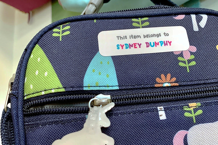 Vinyl identification decal attached to a child's backpack: Personalized name label with colorful design, ensuring easy recognition and safety.