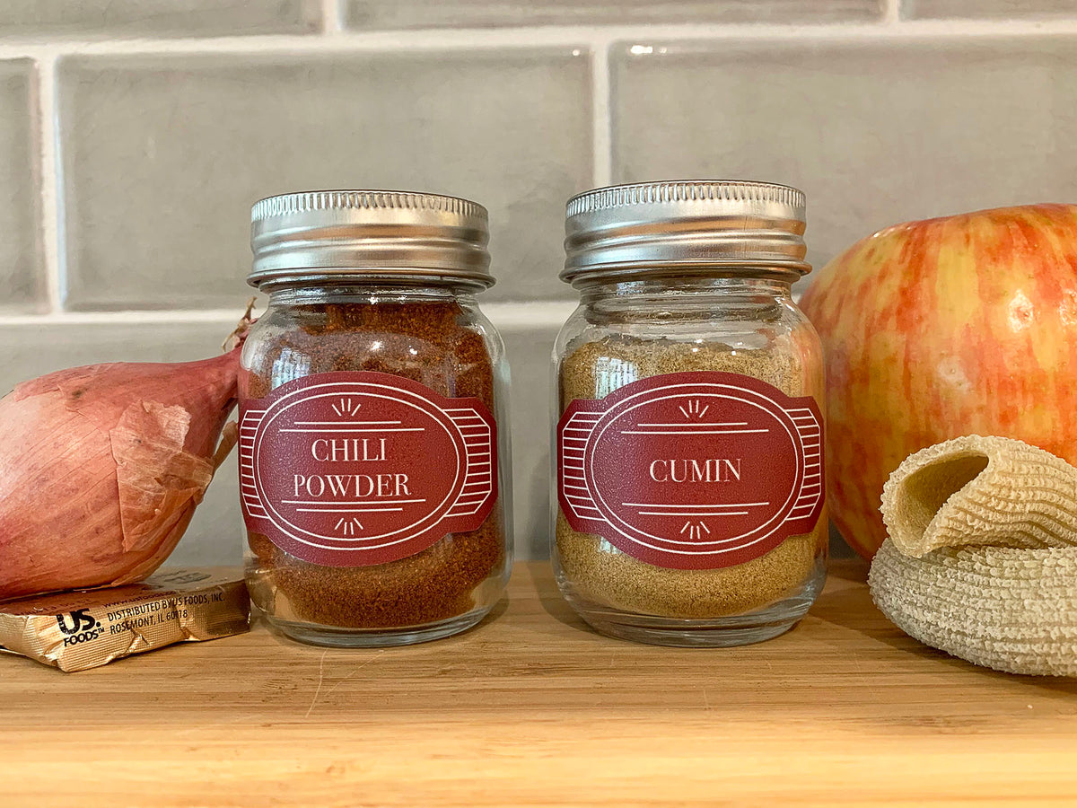 Black vintage-style spice bottle vinyl decals in a kitchen: Classic and elegant labels on spice bottles, reminiscent of vintage design, adding a sophisticated touch to the kitchen decor while ensuring easy identification of various spices.
