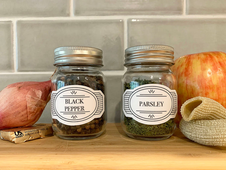 White vintage-style spice bottle vinyl decals in a kitchen: Classic and elegant labels on spice bottles, evoking a vintage aesthetic in the kitchen while ensuring easy identification of the various spices.